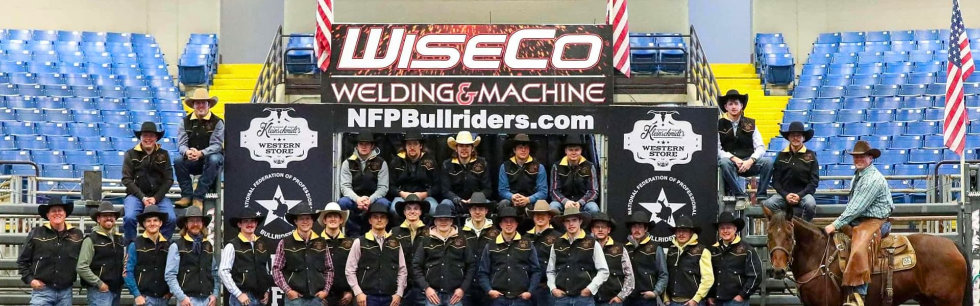 Group photo of youth bull riders in Western attire at an event sponsored by WiseCo Welding & Machine.