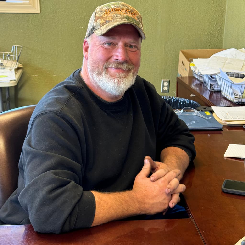 Jeremy, owner of WiseCo Welding & Machine, seated at his desk in Sedalia, Missouri.